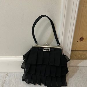 A small evening bag, with ruffles and rhinestones from Claires